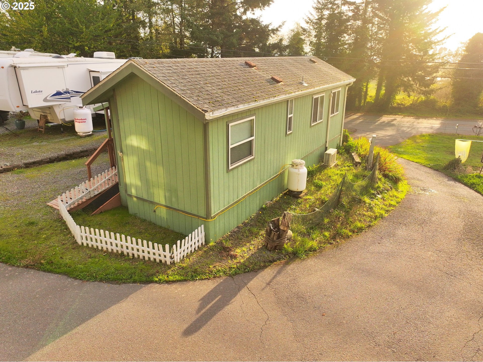 15061 Highway 101, Unit 4 Brookings, OR 97415 - Photo 4 of 19 a view of a house with a yard and potted plants