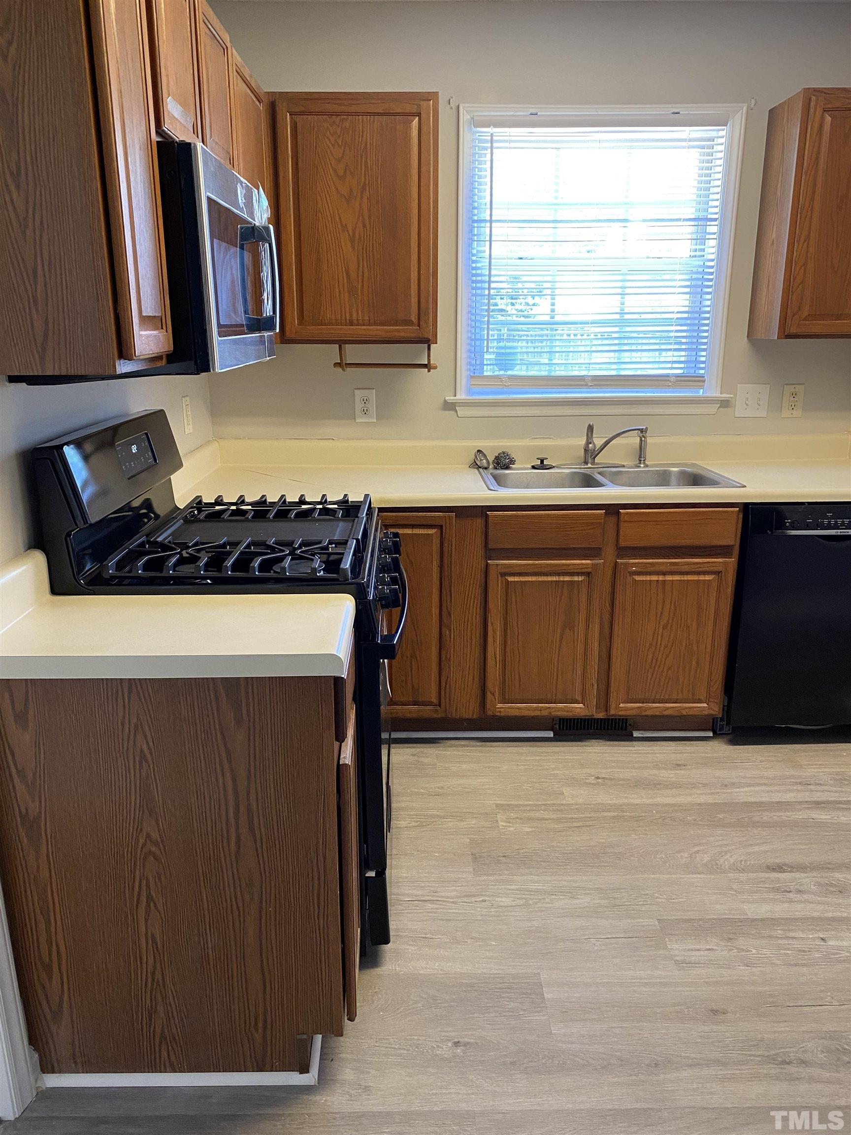 4433 Moss Spring Drive Raleigh, NC 27616 - Photo 15 of 25 a kitchen with stainless steel appliances granite countertop a sink and a stove
