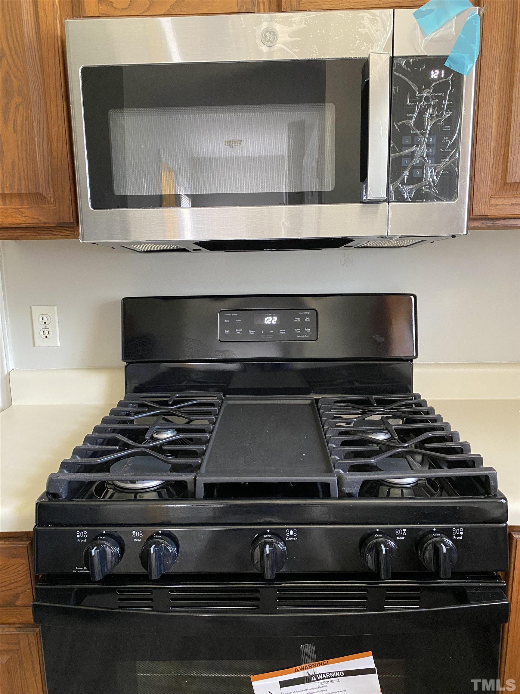 4433 Moss Spring Drive Raleigh, NC 27616 - Photo 16 of 25 a stove top oven sitting inside of a kitchen