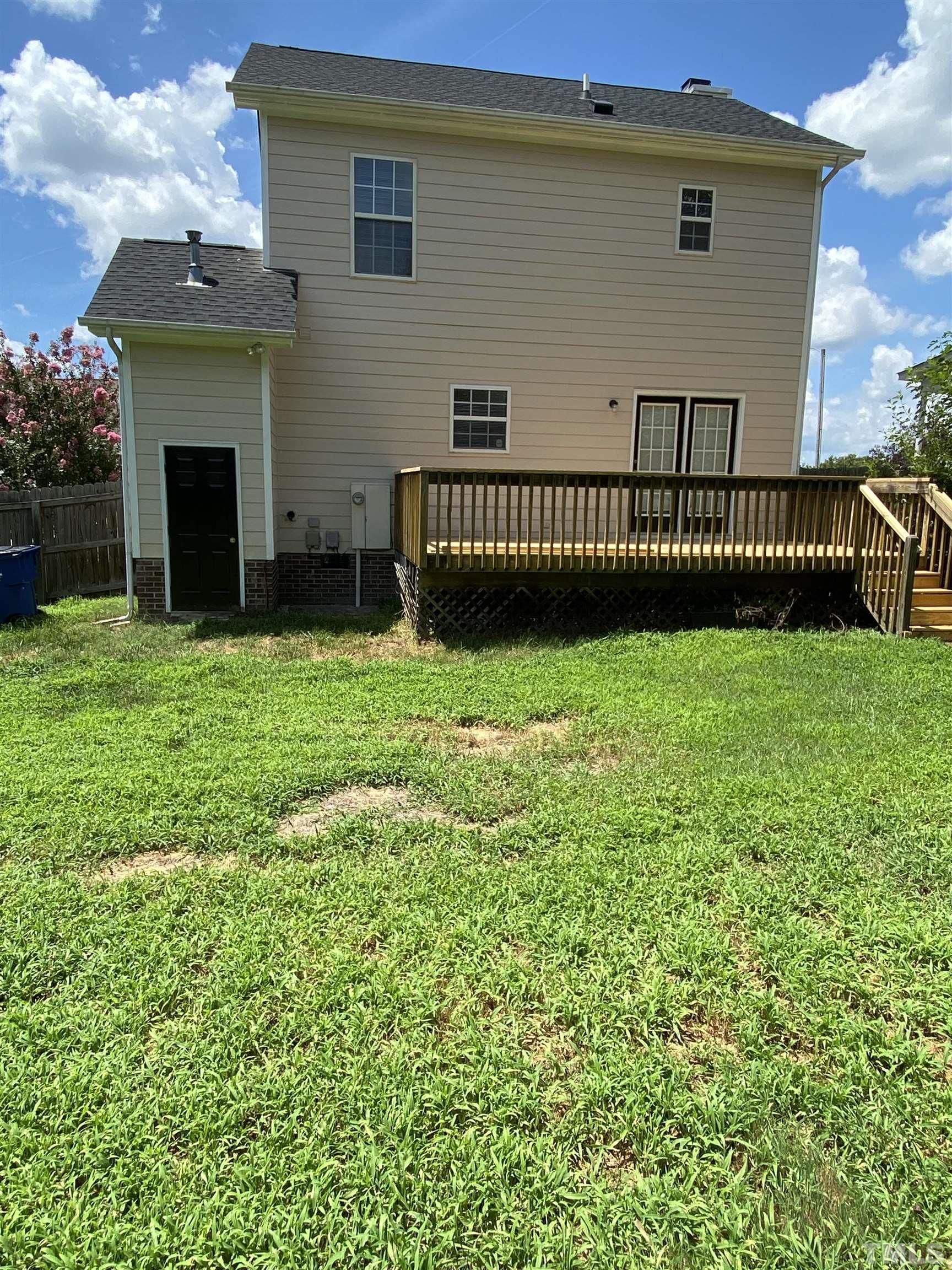 4433 Moss Spring Drive Raleigh, NC 27616 - Photo 23 of 25 a view of a house with a yard and deck