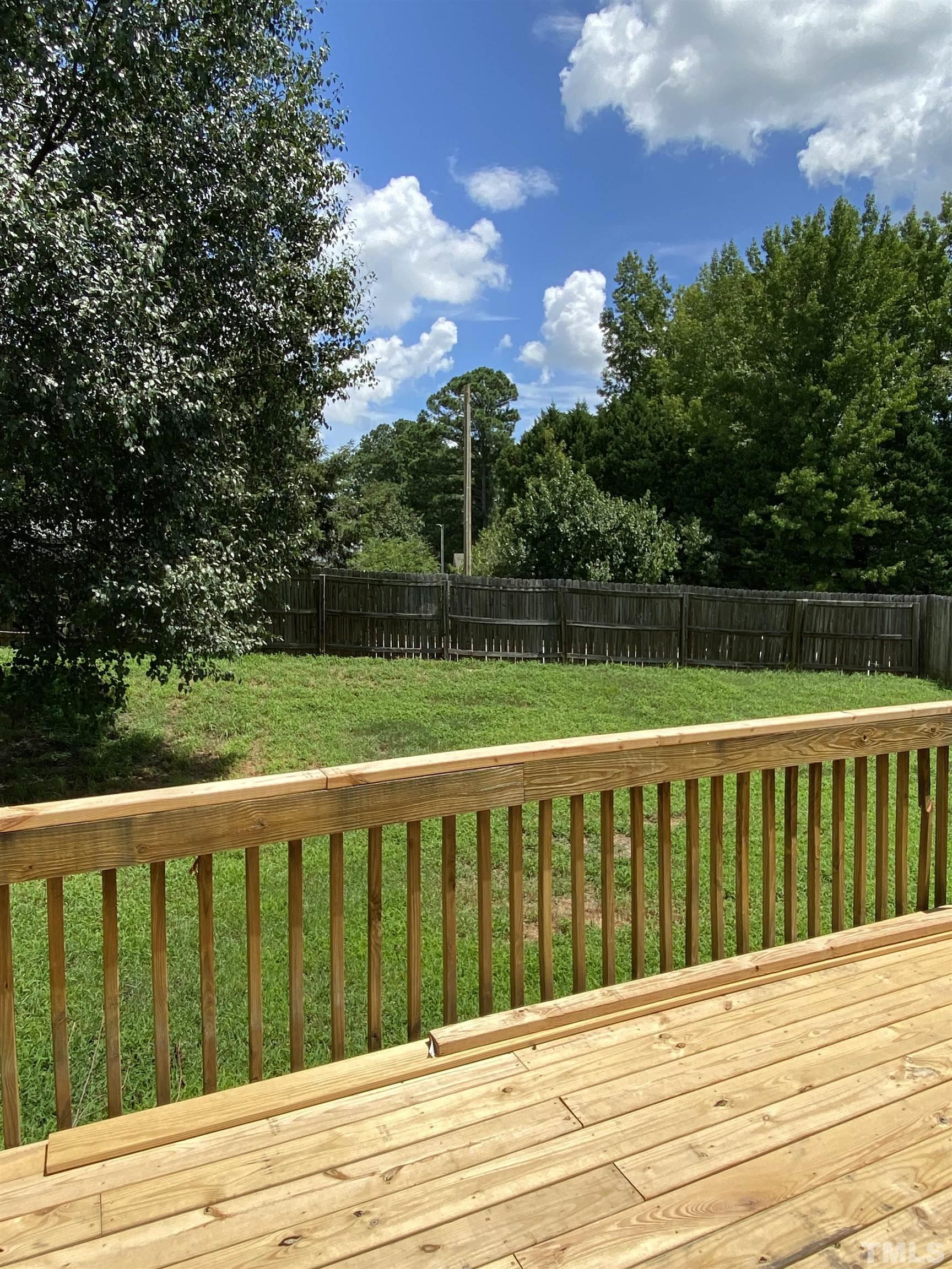 4433 Moss Spring Drive Raleigh, NC 27616 - Photo 24 of 25 a view of wooden deck and a yard