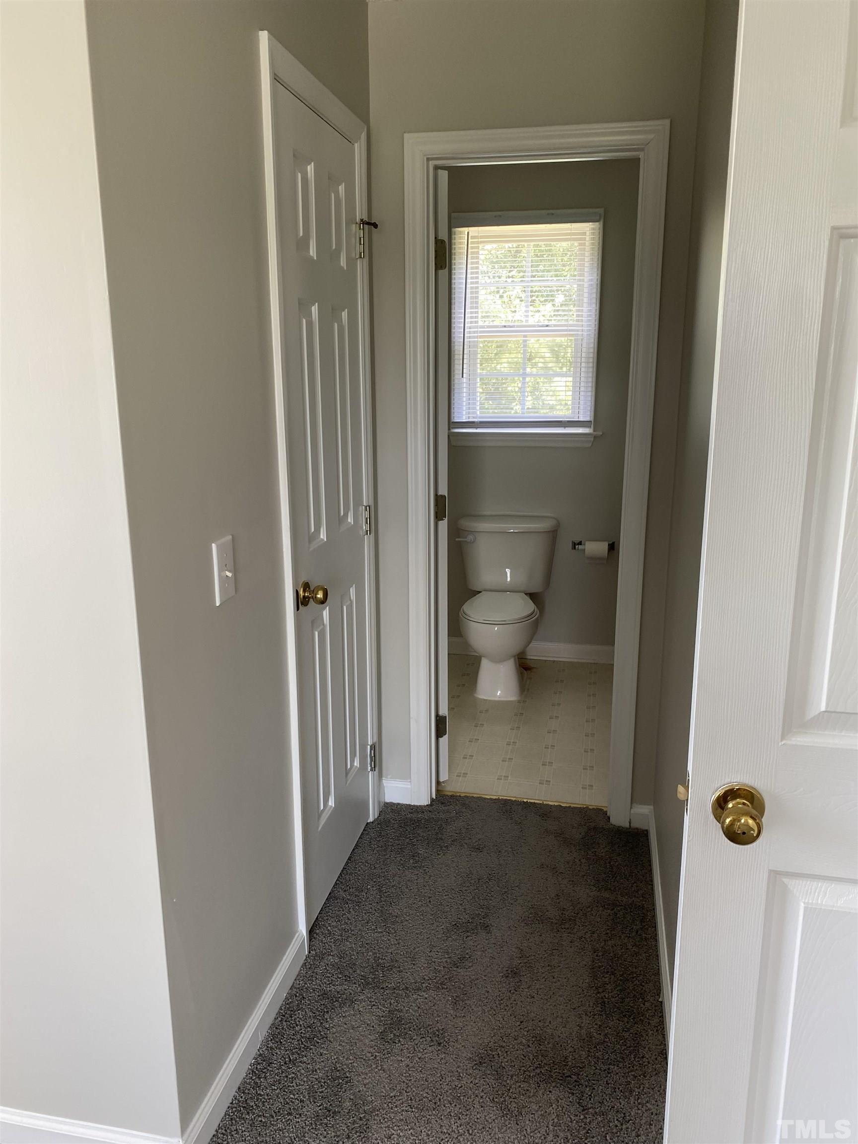 4433 Moss Spring Drive Raleigh, NC 27616 - Photo 3 of 25 a view of a bathroom from a hallway