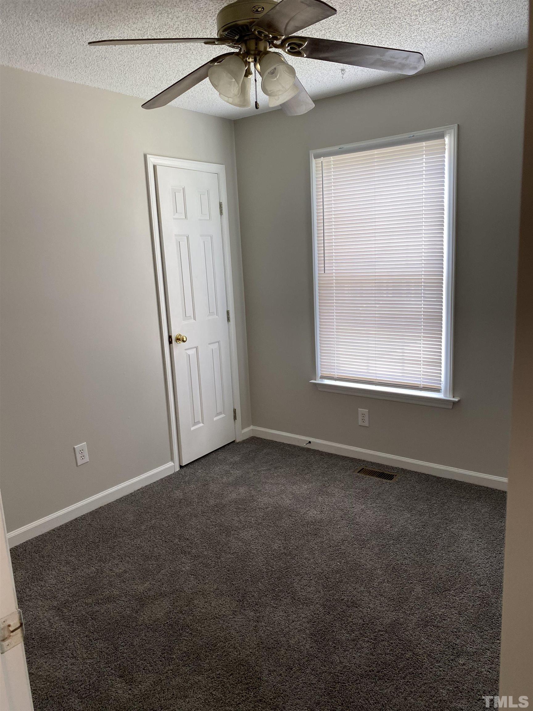 4433 Moss Spring Drive Raleigh, NC 27616 - Photo 4 of 25 an empty room with windows and fan