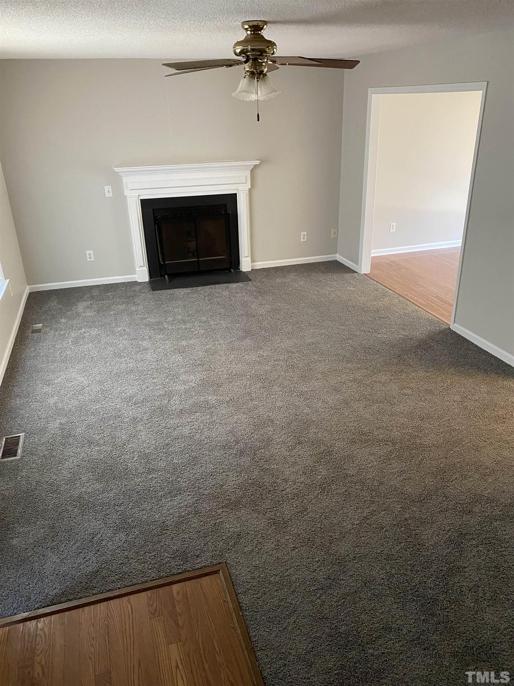 4433 Moss Spring Drive Raleigh, NC 27616 - Photo 6 of 25 a view of empty room with a fireplace