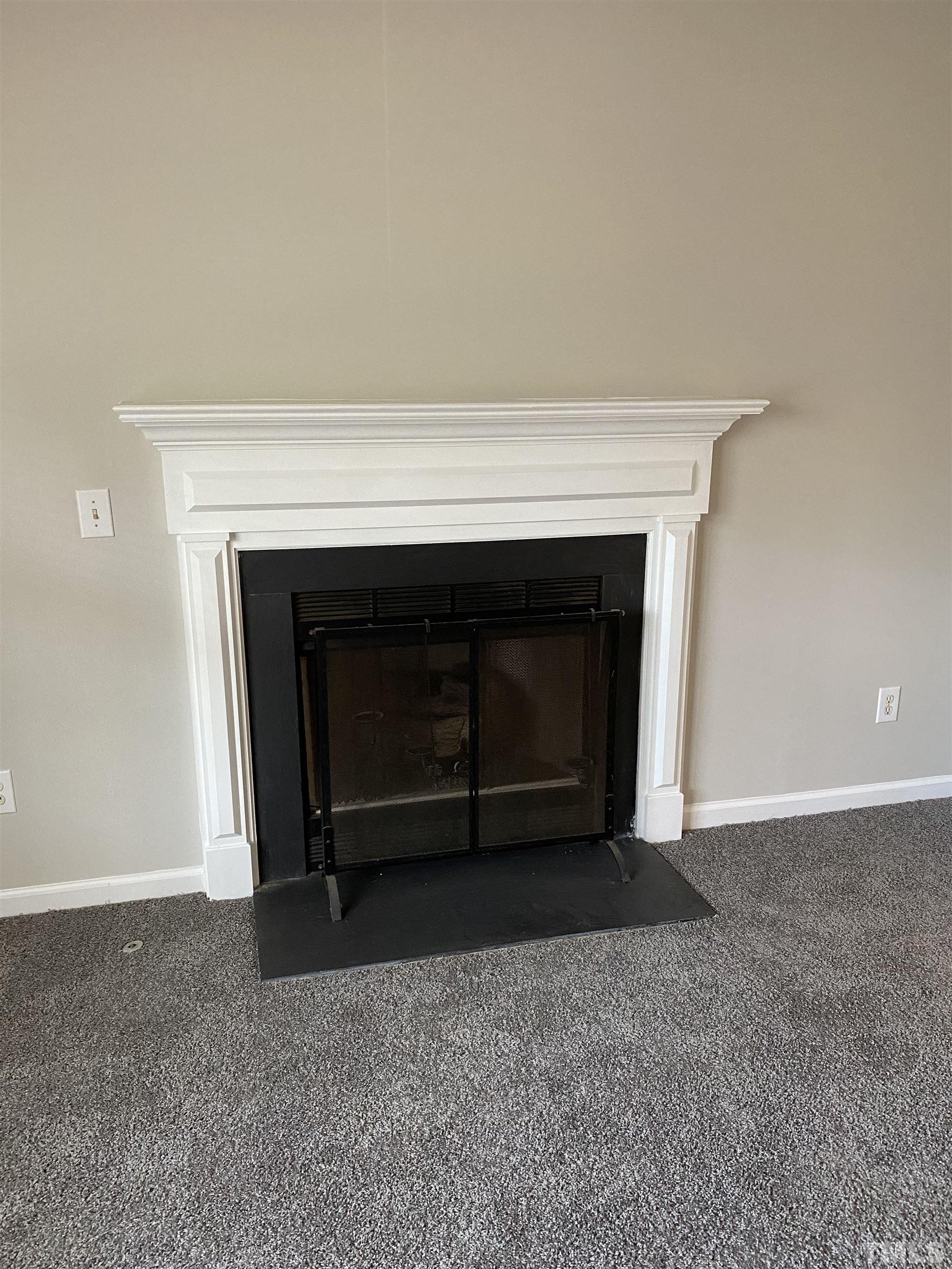 4433 Moss Spring Drive Raleigh, NC 27616 - Photo 10 of 25 a living room with a fireplace