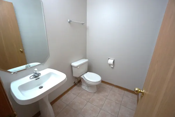 a white toilet sitting next to a bathroom sink