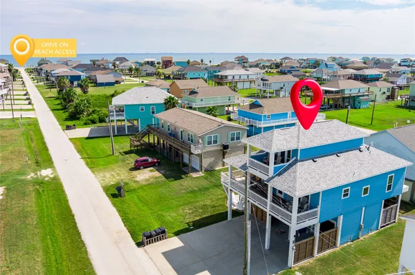 a view of multiple houses with outdoor space and pool