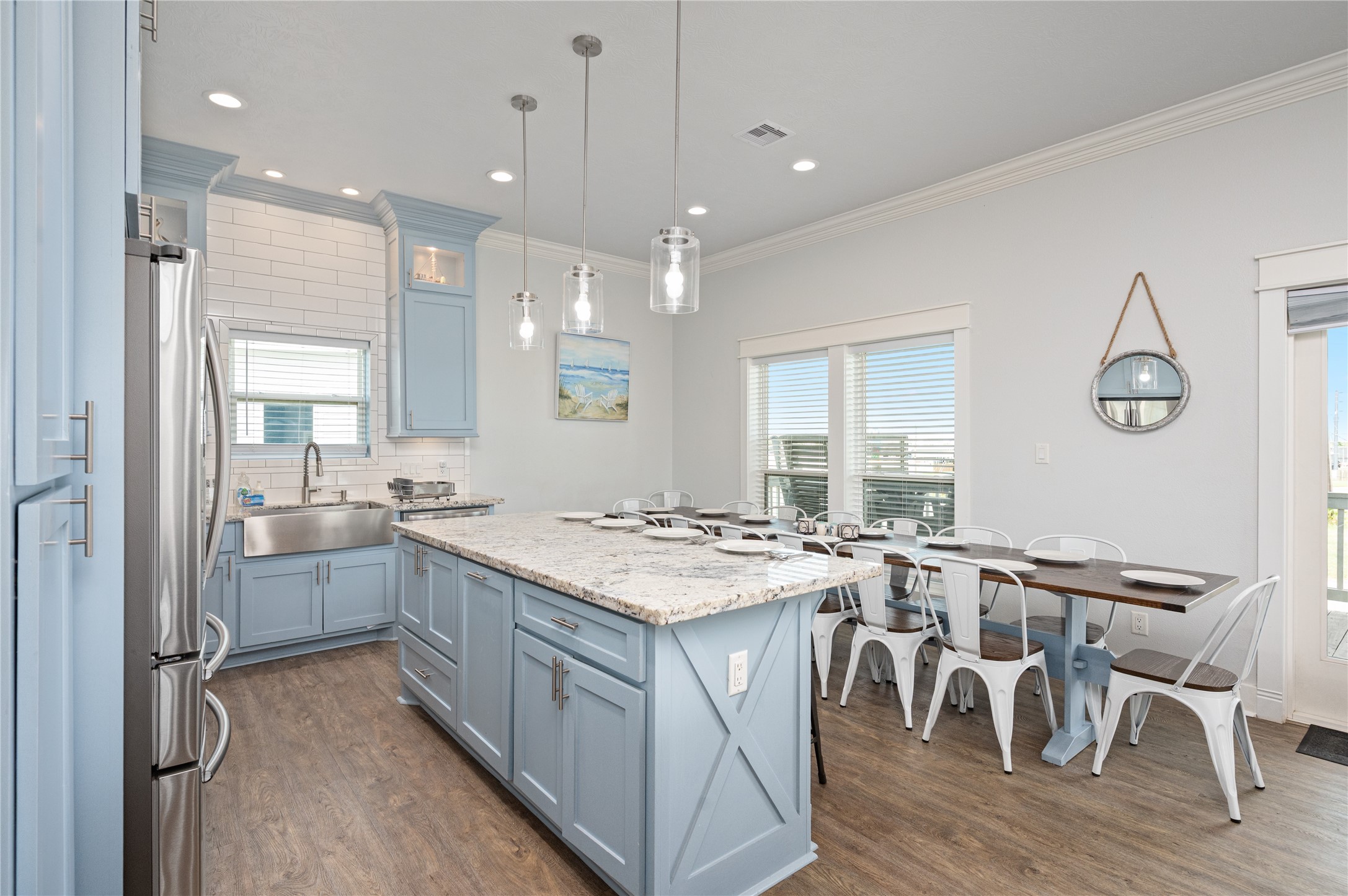 997 South Redfish Crystal Beach, TX 77650 - Photo 13 of 45 a kitchen with sink cabinets and wooden floor