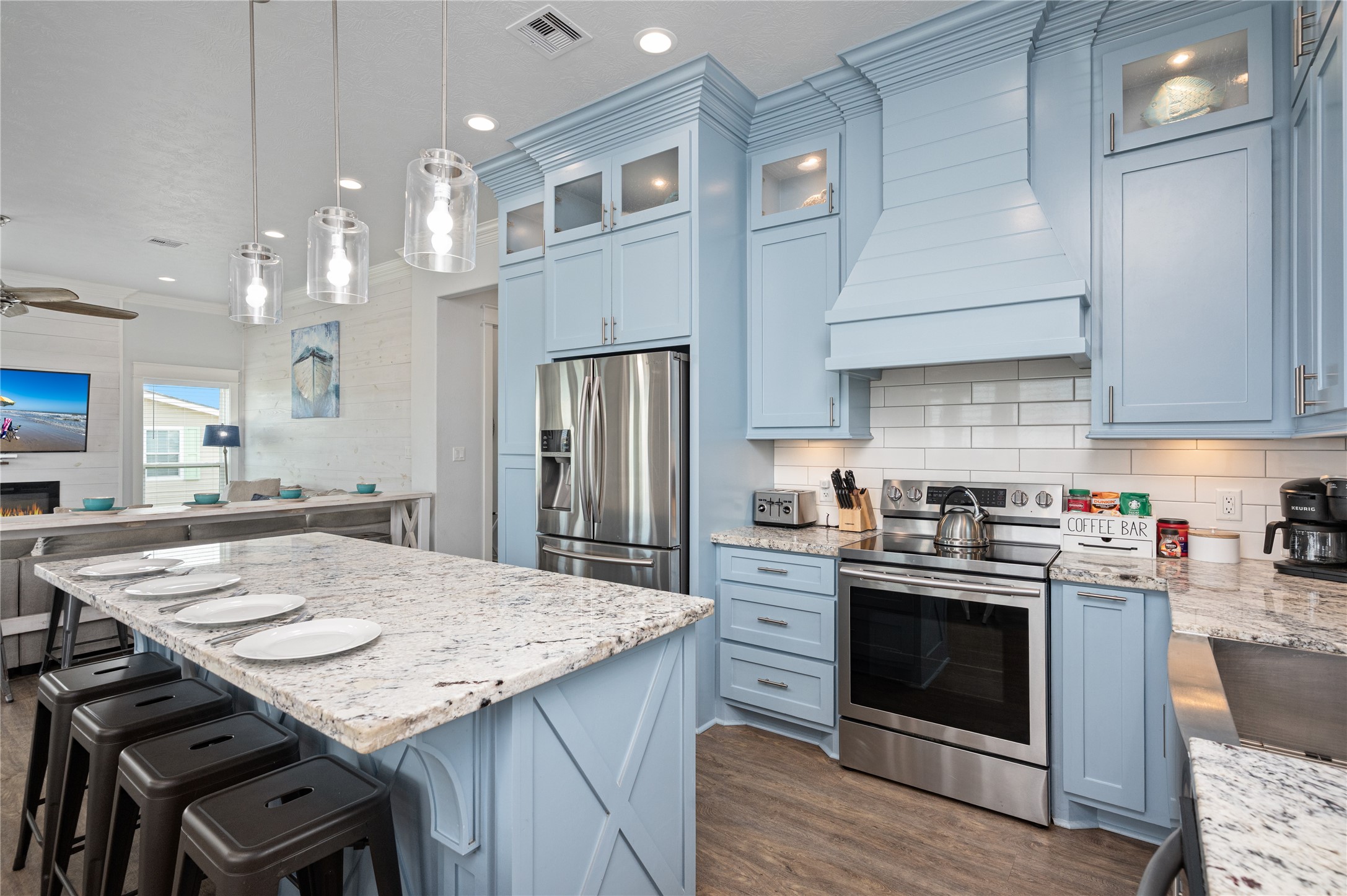 997 South Redfish Crystal Beach, TX 77650 - Photo 14 of 45 a kitchen with kitchen island a stove a table and chairs in it