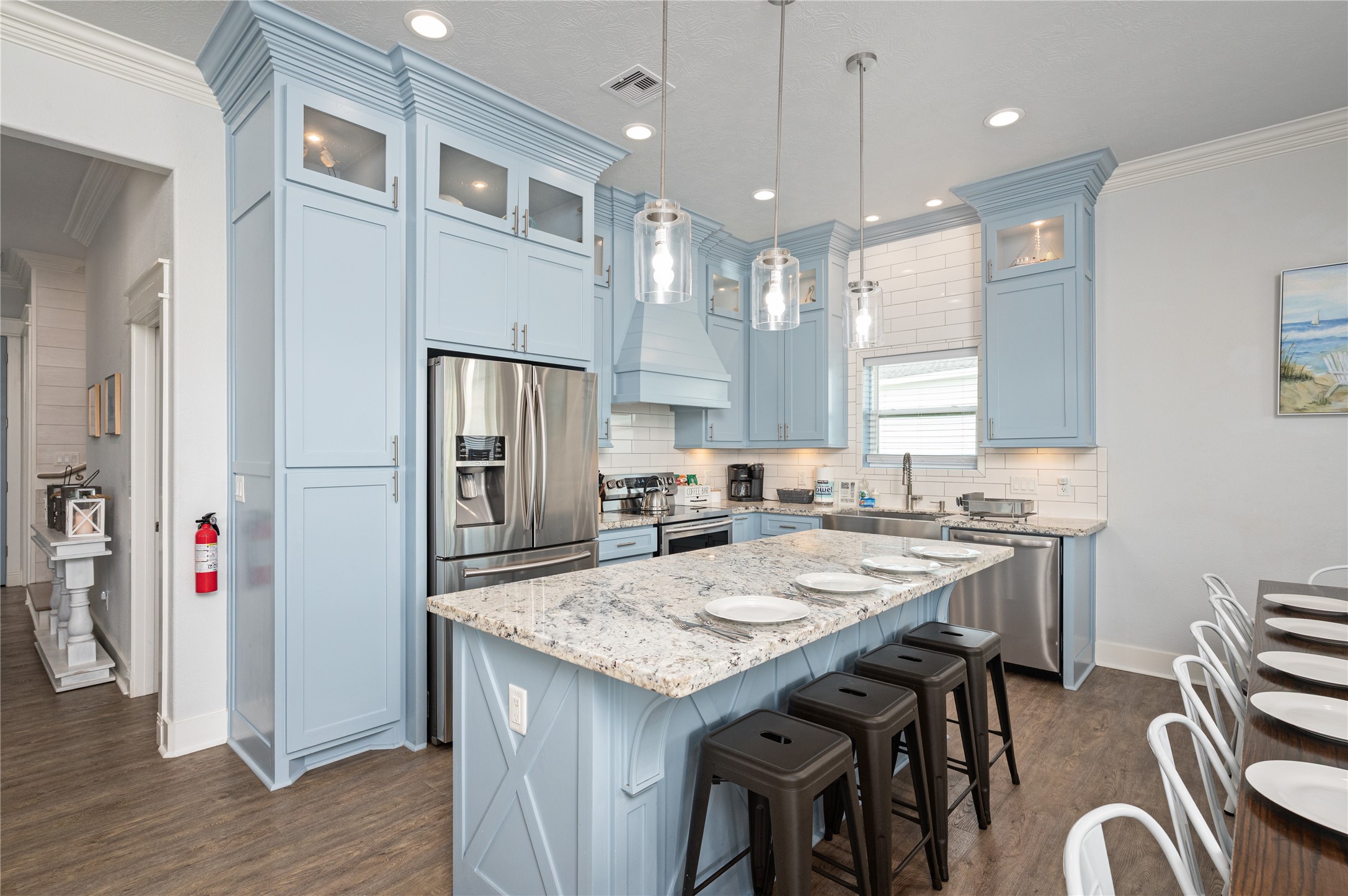 997 South Redfish Crystal Beach, TX 77650 - Photo 15 of 45 a kitchen with granite countertop a refrigerator a stove a sink a dining table and chairs