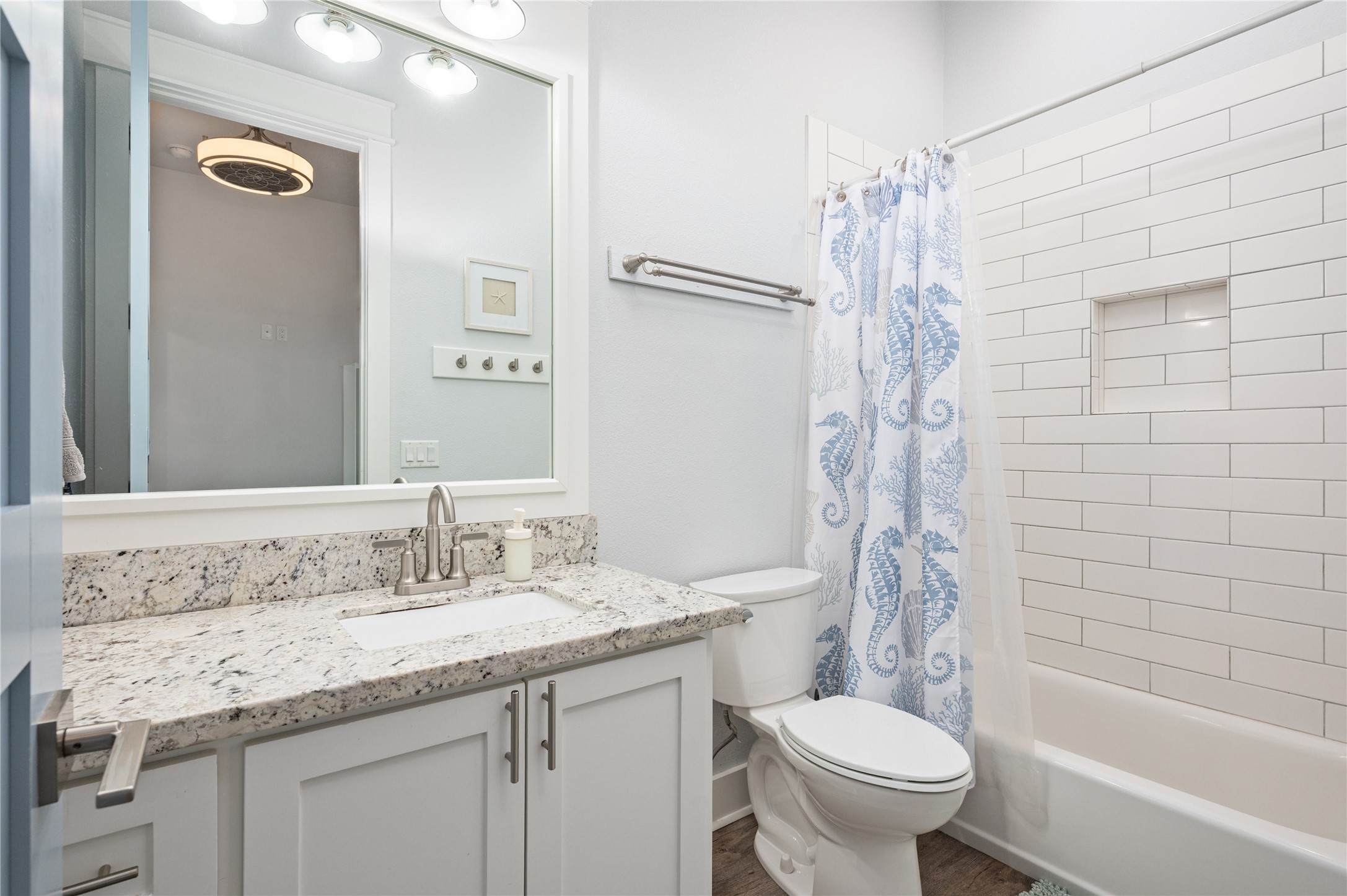 997 South Redfish Crystal Beach, TX 77650 - Photo 22 of 45 a bathroom with a granite countertop sink toilet and shower