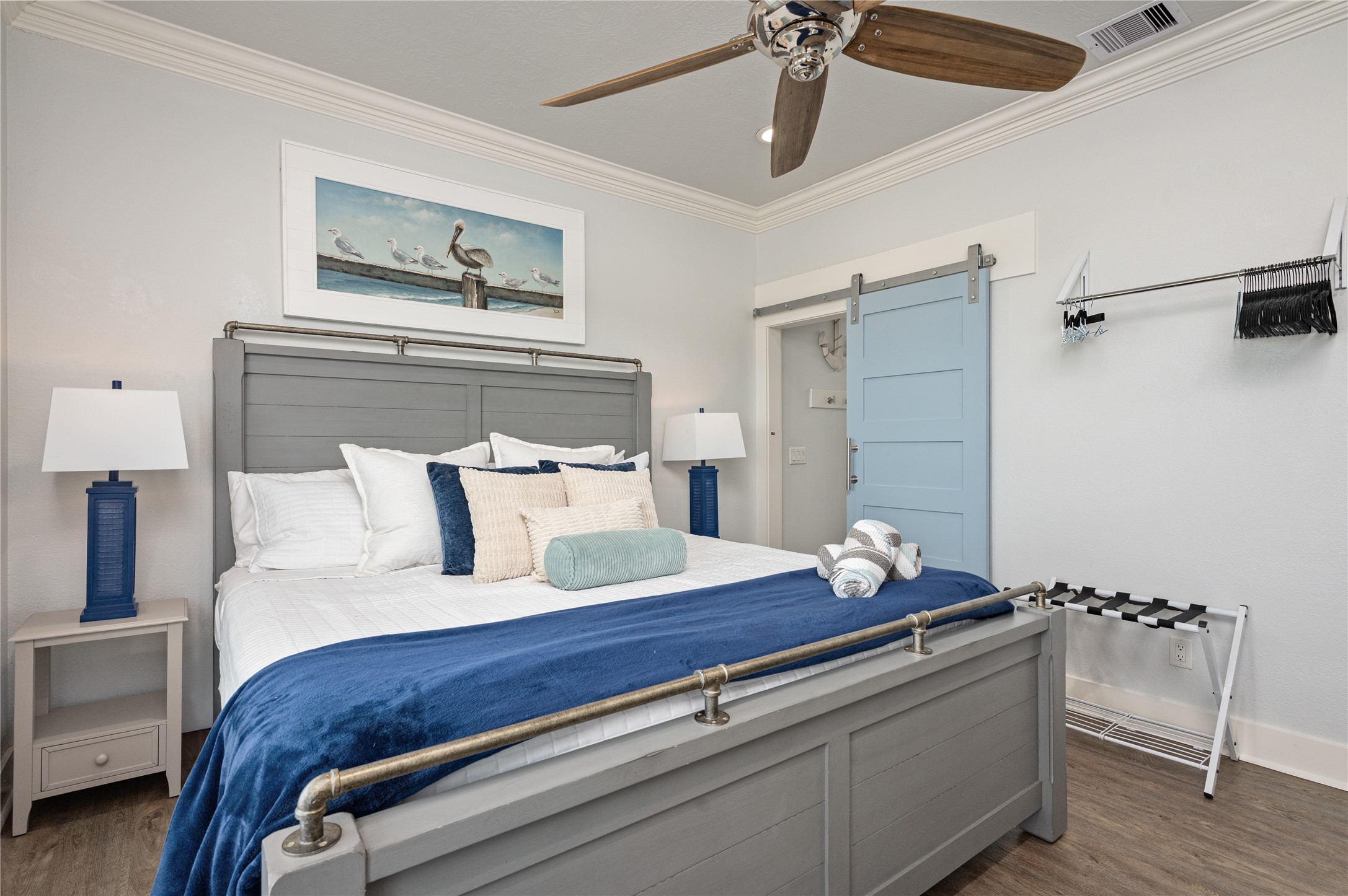 997 South Redfish Crystal Beach, TX 77650 - Photo 29 of 45 a bedroom with a bed and wooden floor