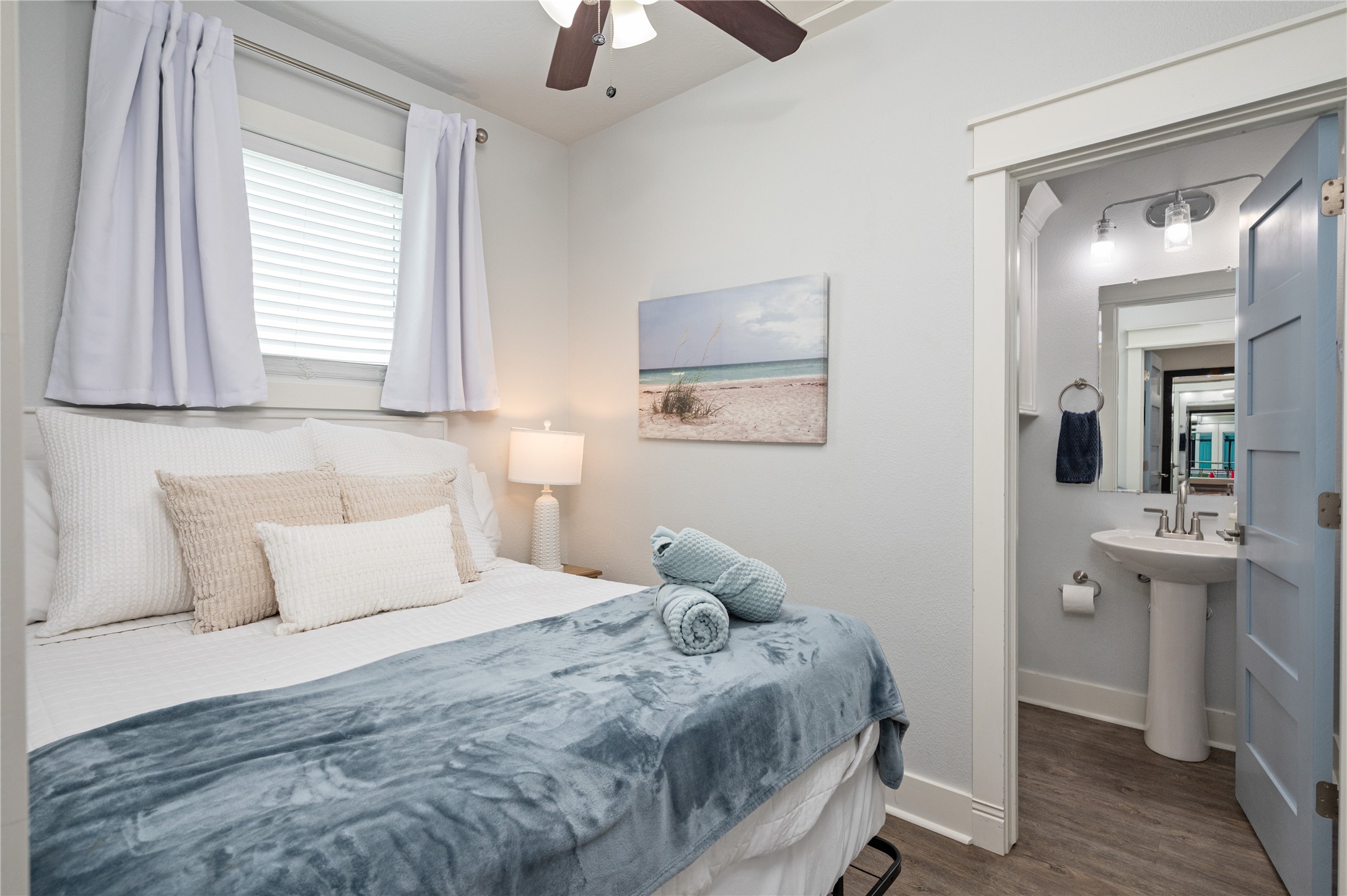 997 South Redfish Crystal Beach, TX 77650 - Photo 32 of 45 a bedroom with a large bed and a chandelier