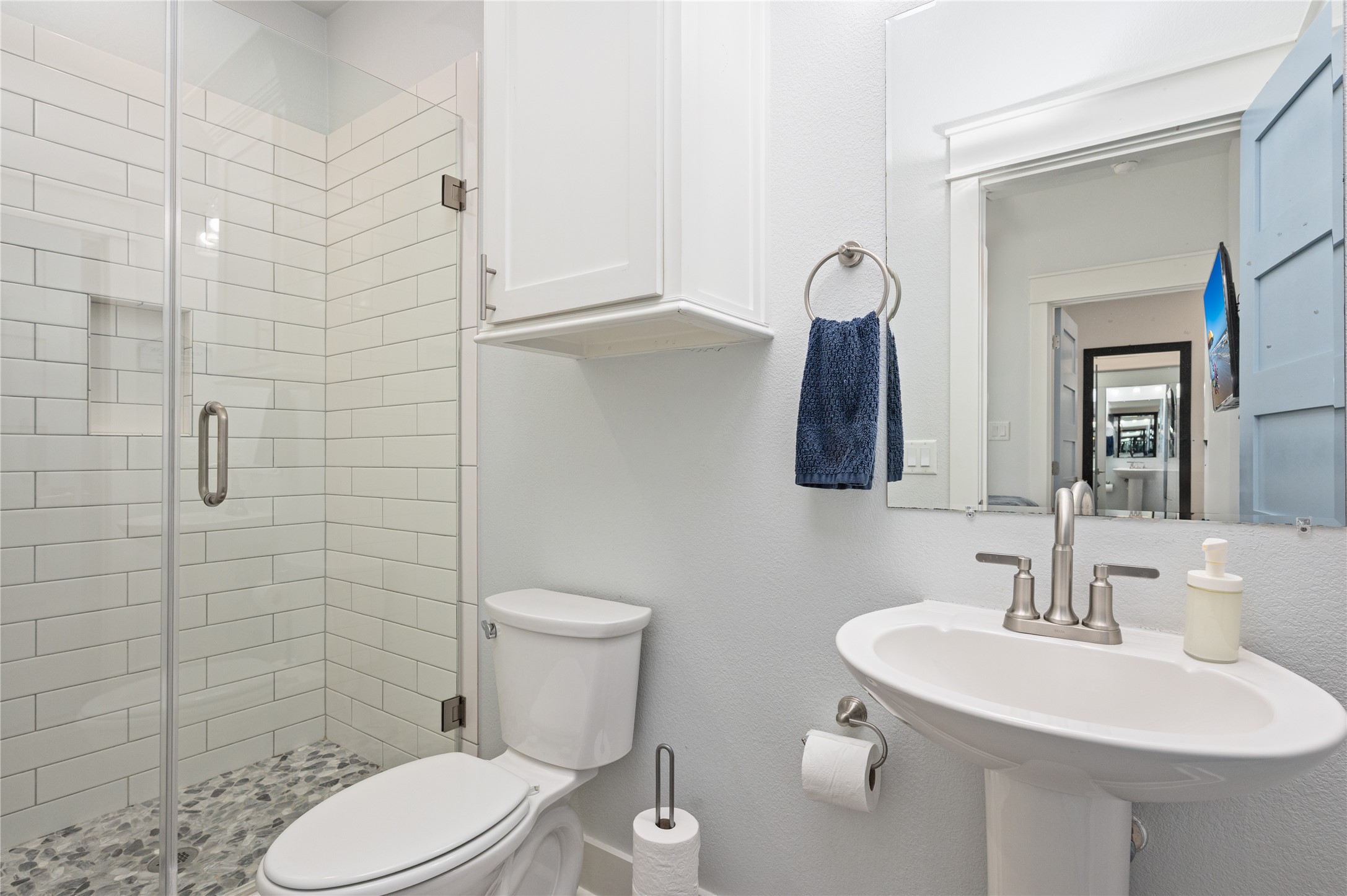 997 South Redfish Crystal Beach, TX 77650 - Photo 34 of 45 a bathroom with a toilet sink and mirror