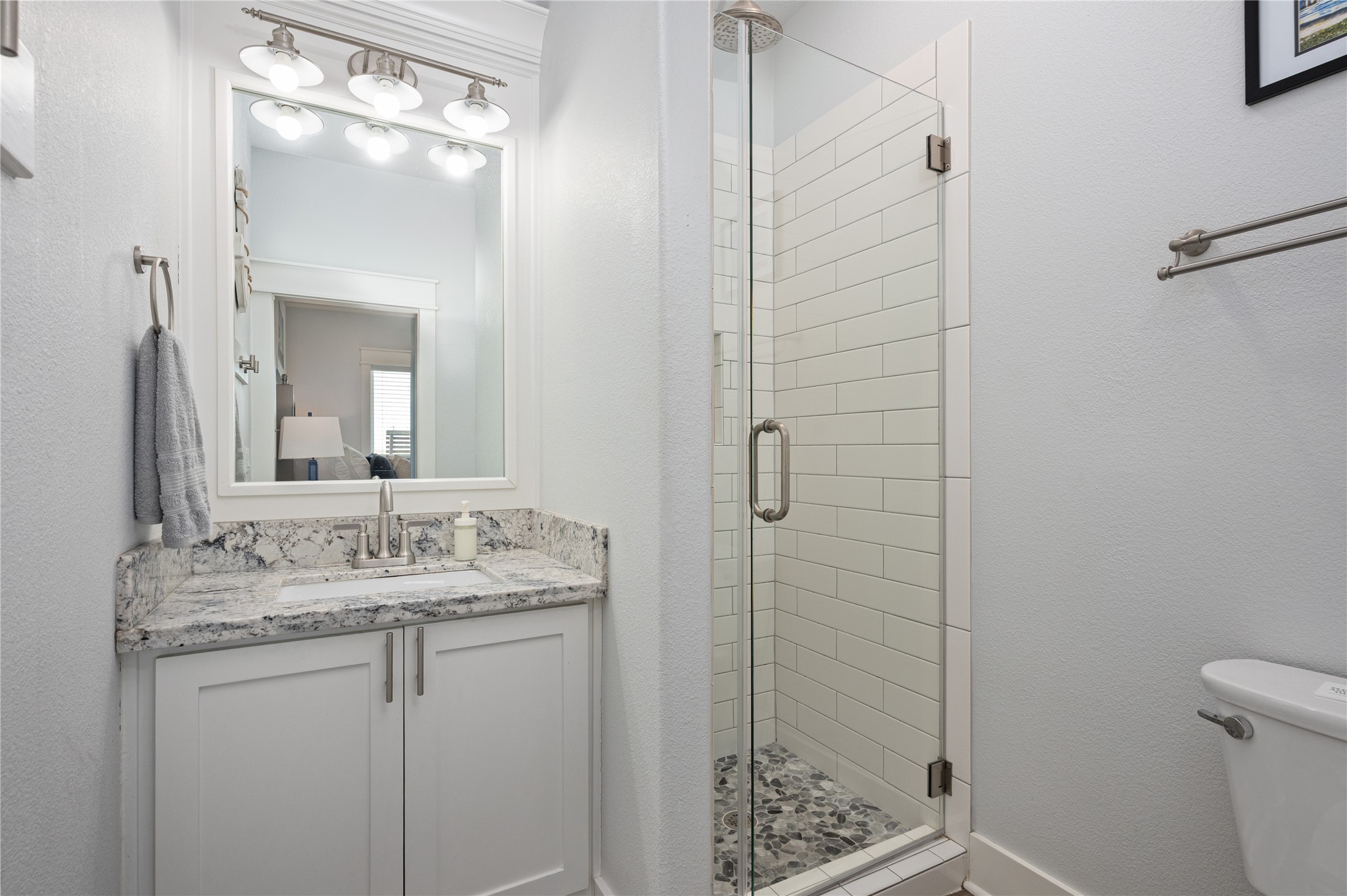 997 South Redfish Crystal Beach, TX 77650 - Photo 35 of 45 a bathroom with a granite countertop sink toilet and shower