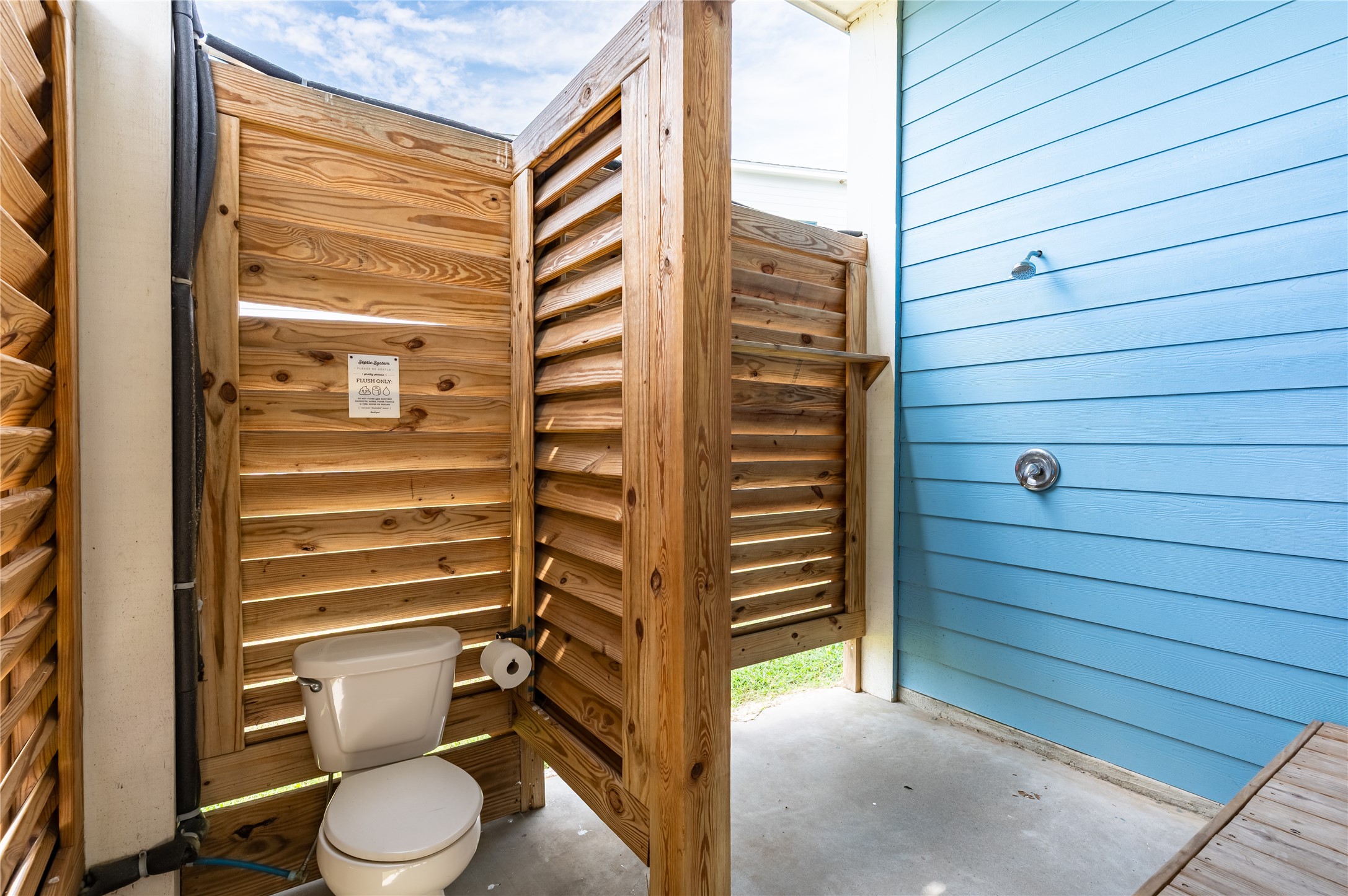 997 South Redfish Crystal Beach, TX 77650 - Photo 41 of 45 a bathroom with a toilet and a shower curtain