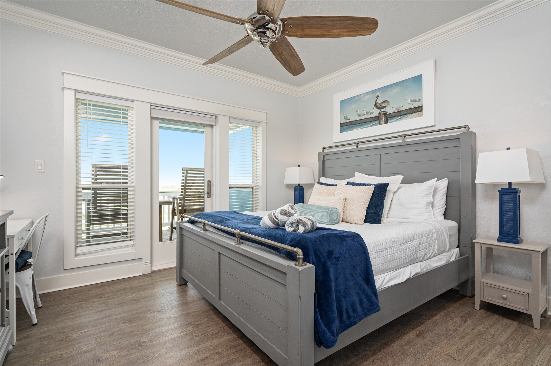 997 South Redfish Crystal Beach, TX 77650 - Photo 5 of 45 a large bed sitting in a bedroom next to a window and a chandelier