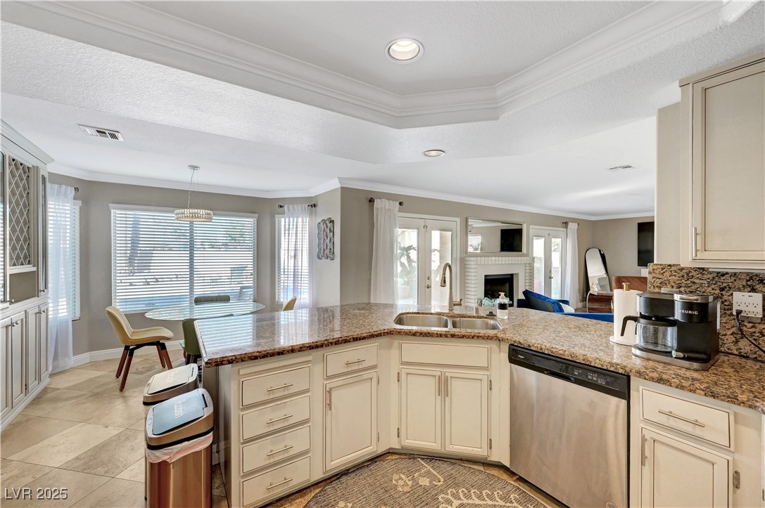 1486 Powder Horn Drive Henderson, NV 89014 - Photo 98 of 99 Kitchen with ornamental molding, dishwasher, a fireplace, open floor plan, and recessed lighting