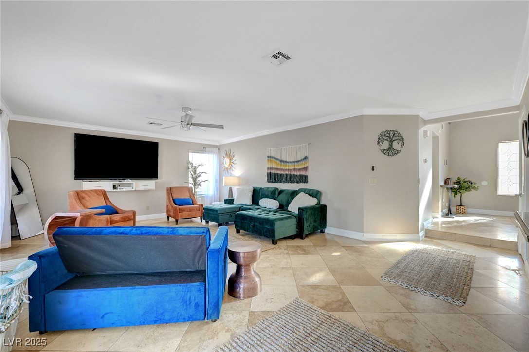 1486 Powder Horn Drive Henderson, NV 89014 - Photo 31 of 99 Living area featuring ornamental molding, a ceiling fan, and light tile patterned flooring