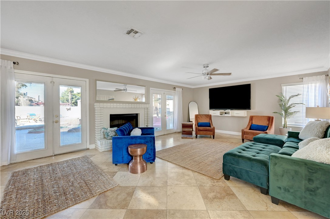 1486 Powder Horn Drive Henderson, NV 89014 - Photo 32 of 99 Living area featuring french doors, plenty of natural light, crown molding, and ceiling fan