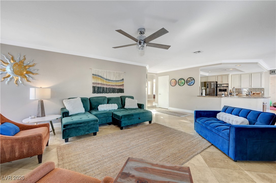 1486 Powder Horn Drive Henderson, NV 89014 - Photo 34 of 99 Living room featuring ornamental molding and ceiling fan