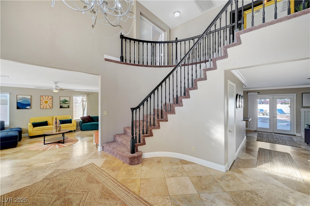 1486 Powder Horn Drive Henderson, NV 89014 - Photo 4 of 99 Entryway featuring a towering ceiling, french doors, stairs, and a chandelier