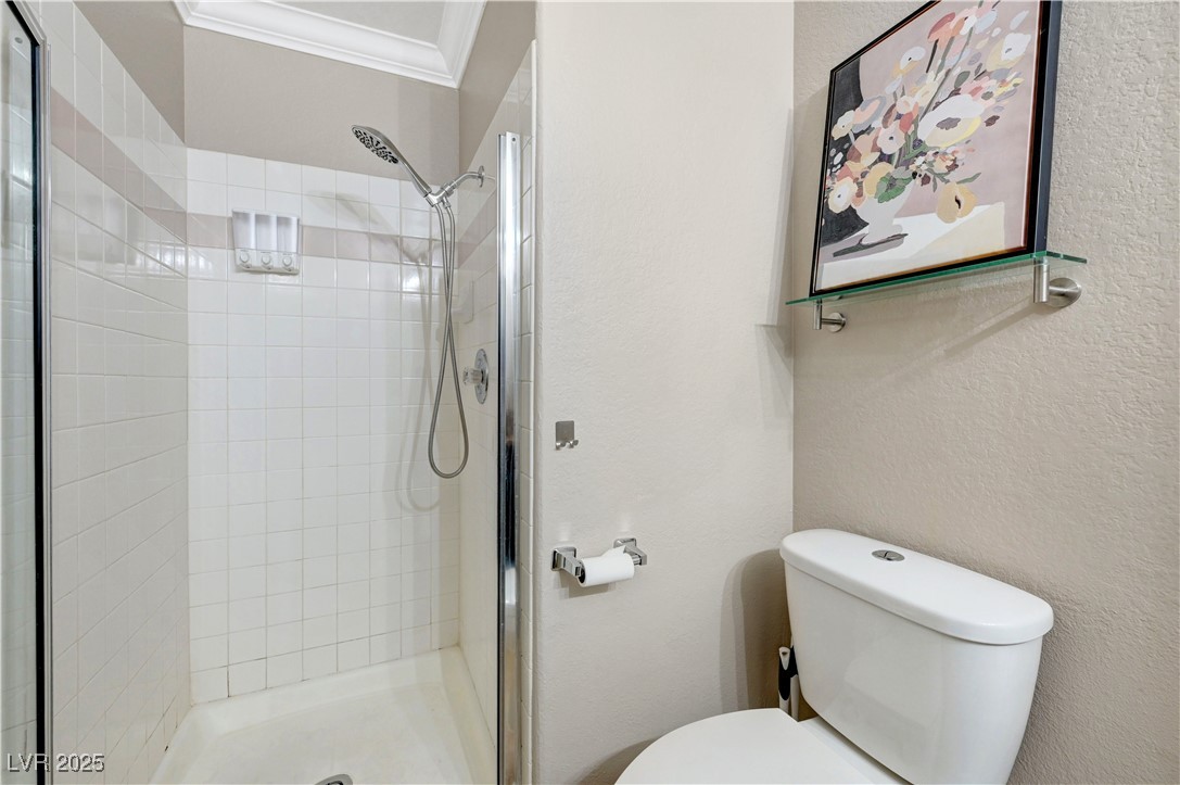 1486 Powder Horn Drive Henderson, NV 89014 - Photo 40 of 99 Full bathroom with a shower stall, a textured wall, and crown molding