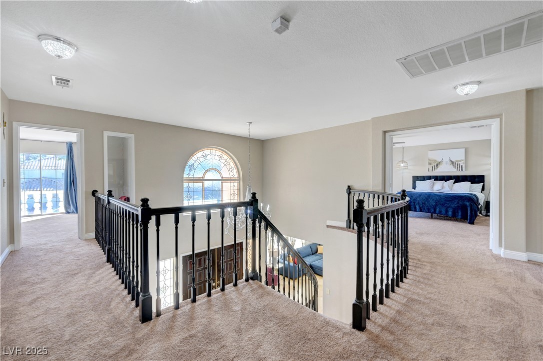 1486 Powder Horn Drive Henderson, NV 89014 - Photo 45 of 99 Hallway featuring carpet floors and an upstairs landing