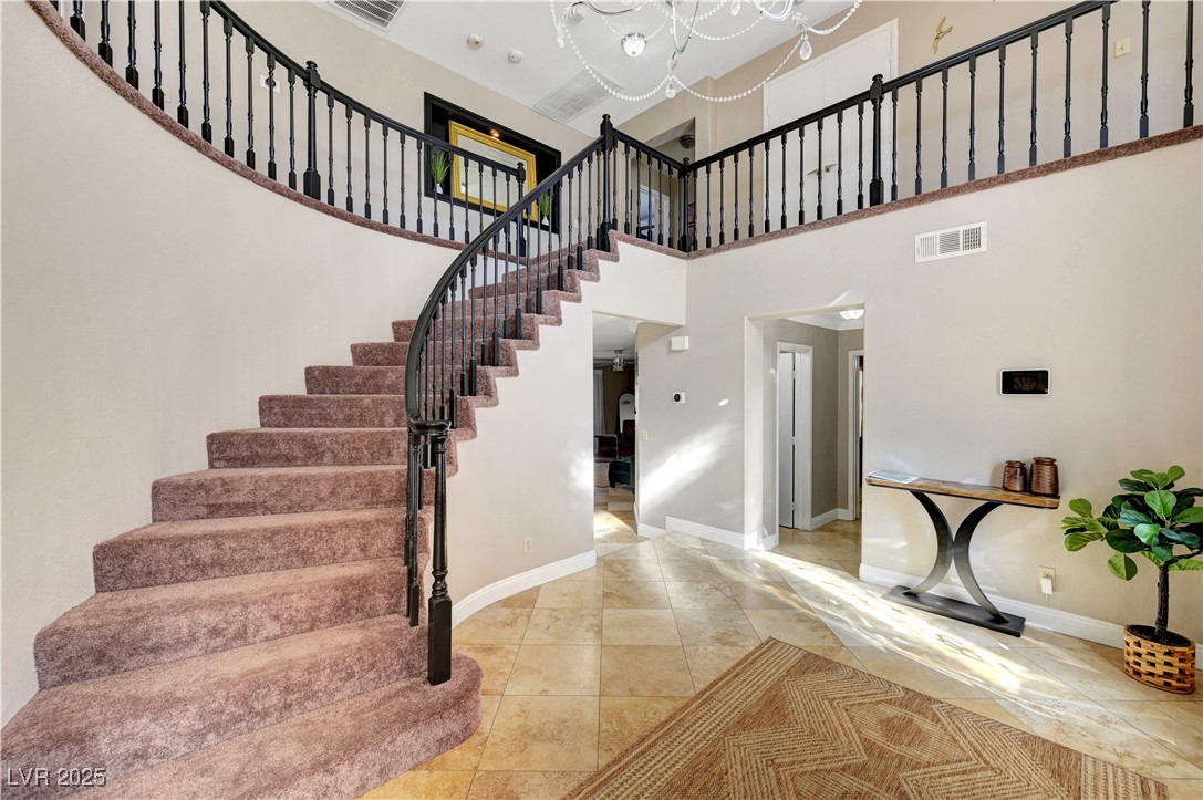1486 Powder Horn Drive Henderson, NV 89014 - Photo 5 of 99 Stairs featuring baseboards and a towering ceiling