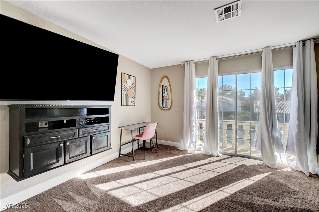 1486 Powder Horn Drive Henderson, NV 89014 - Photo 51 of 99 Living room featuring light carpet and baseboards