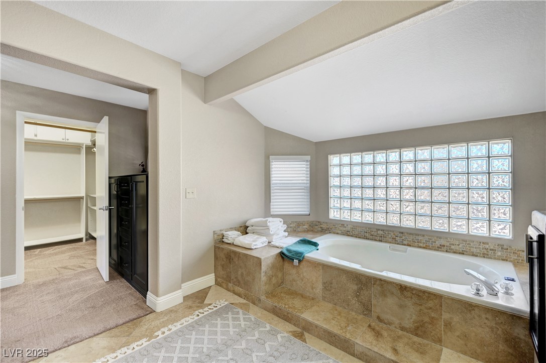 1486 Powder Horn Drive Henderson, NV 89014 - Photo 54 of 99 Full bath with a garden tub, a walk in closet, light carpet, and light tile patterned floors