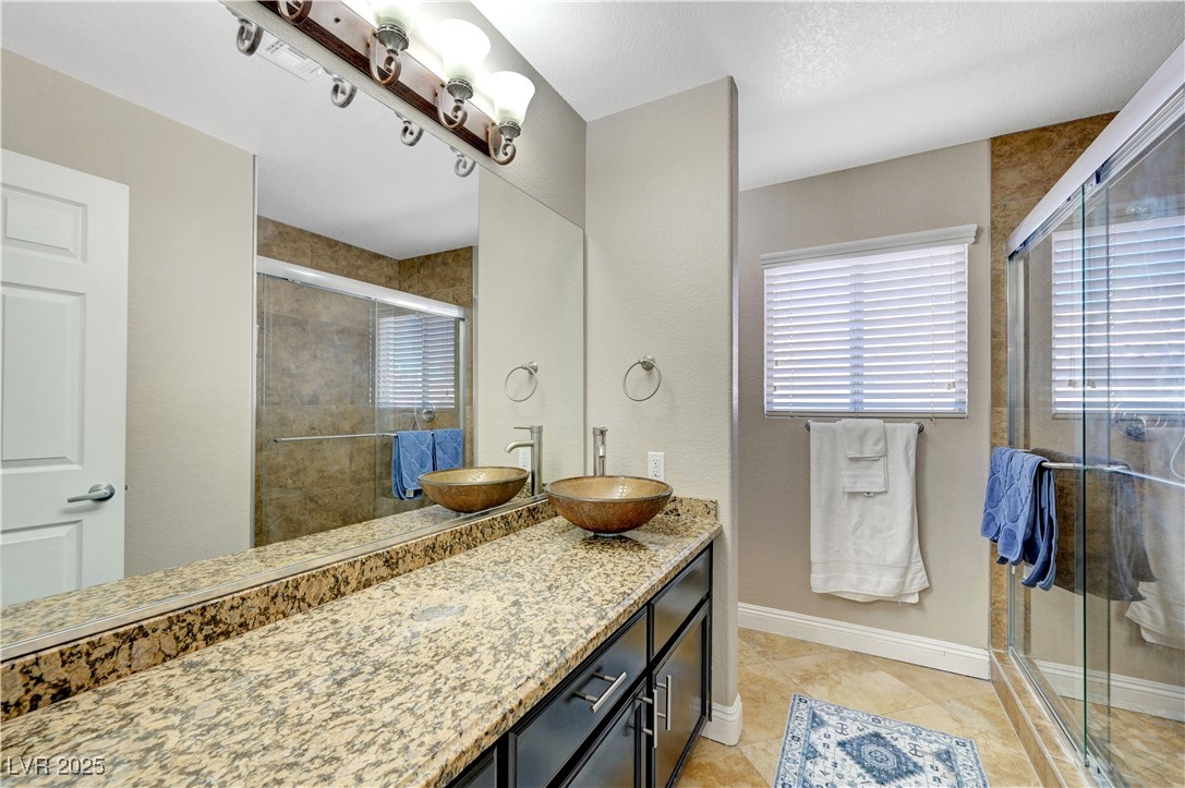1486 Powder Horn Drive Henderson, NV 89014 - Photo 65 of 99 Full bathroom featuring vanity, a stall shower, and light tile patterned flooring