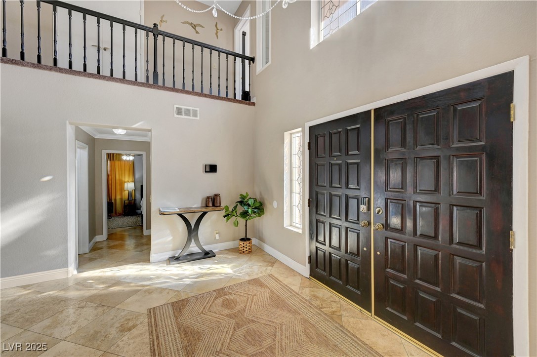 1486 Powder Horn Drive Henderson, NV 89014 - Photo 7 of 99 Foyer entrance with a high ceiling and ornamental molding