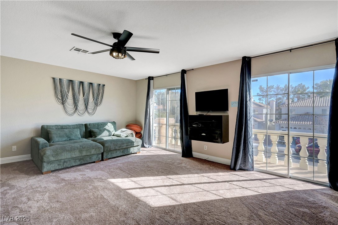 1486 Powder Horn Drive Henderson, NV 89014 - Photo 73 of 99 Living room featuring light colored carpet and ceiling fan