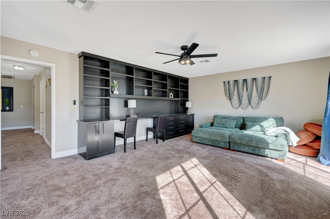 1486 Powder Horn Drive Henderson, NV 89014 - Photo 74 of 99 Living room featuring an office area, light carpet, and ceiling fan