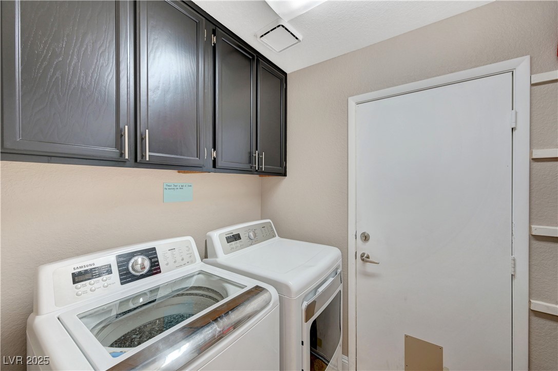 1486 Powder Horn Drive Henderson, NV 89014 - Photo 78 of 99 Laundry room with washer and dryer, cabinet space, and a textured wall