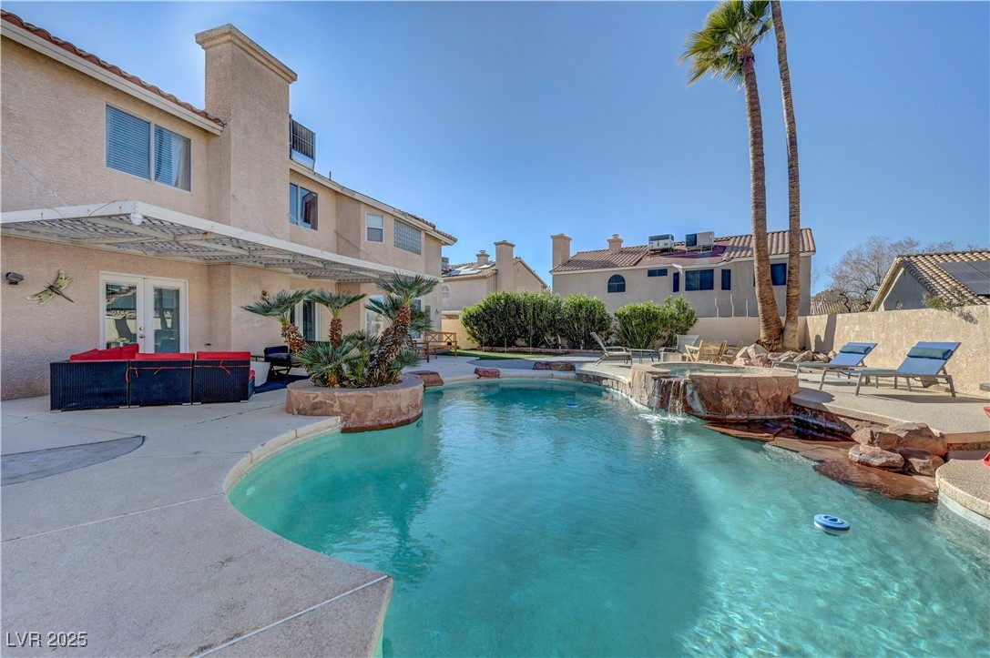 1486 Powder Horn Drive Henderson, NV 89014 - Photo 81 of 99 View of swimming pool with a pool with connected hot tub, a patio area, and outdoor lounge area