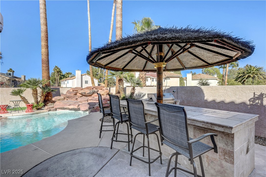 1486 Powder Horn Drive Henderson, NV 89014 - Photo 94 of 99 Fenced backyard featuring an outdoor kitchen and a patio
