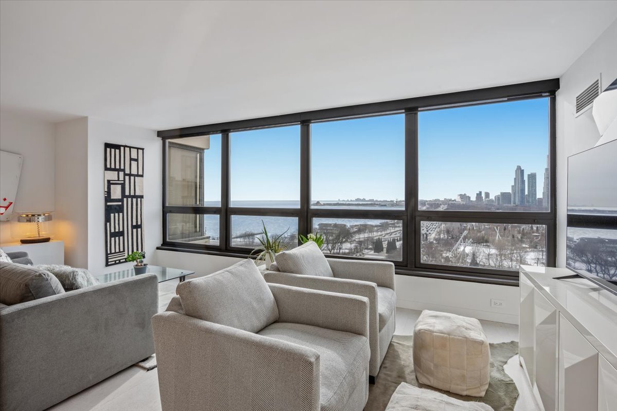 360 East Randolph Street, Unit 1002 Chicago, IL 60601 - Photo 13 of 27 a living room with furniture and a large window
