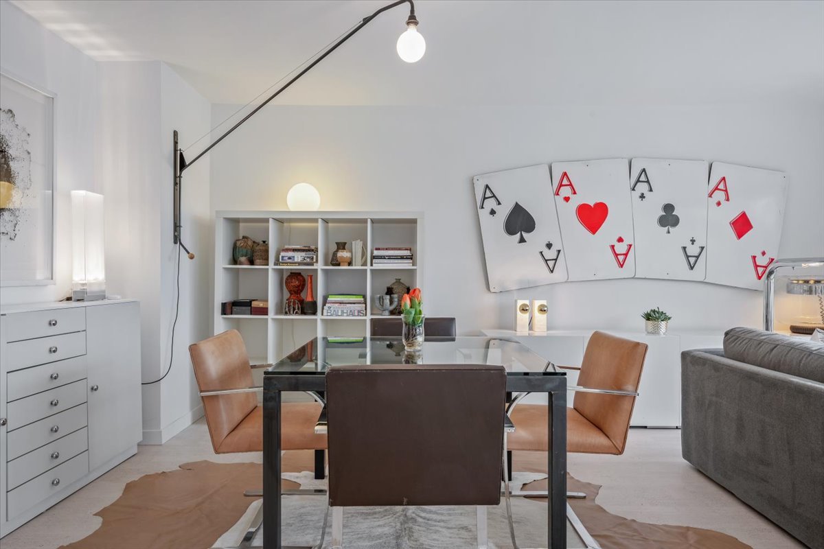 360 East Randolph Street, Unit 1002 Chicago, IL 60601 - Photo 16 of 27 a view of a dining room with furniture and a book shelf