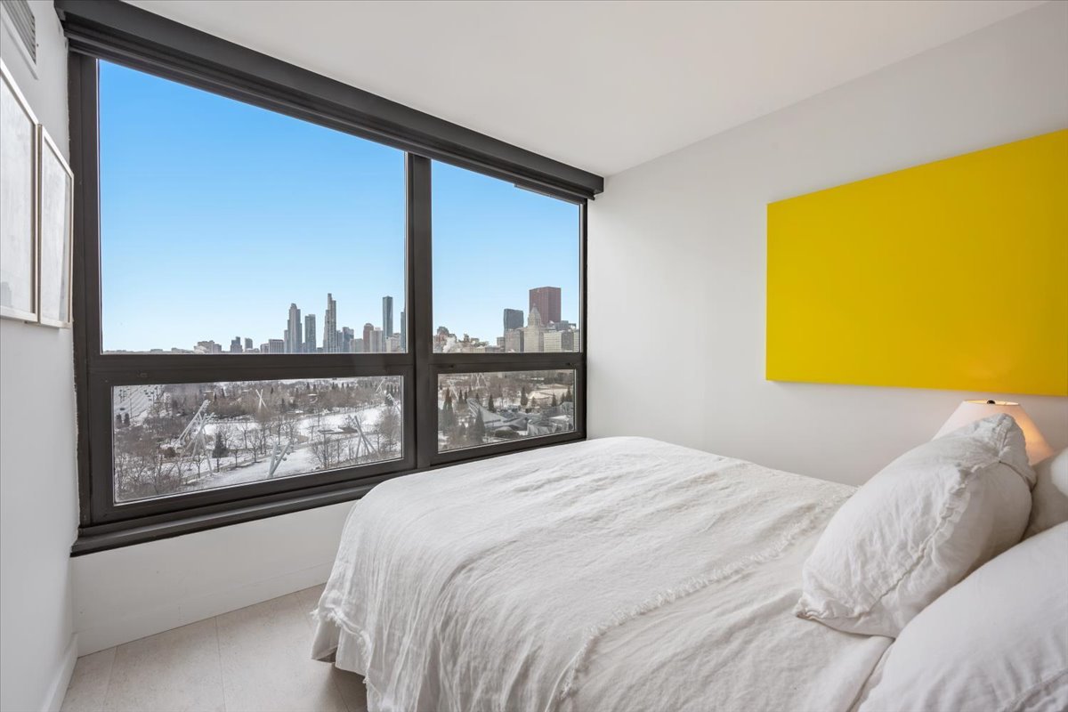 360 East Randolph Street, Unit 1002 Chicago, IL 60601 - Photo 17 of 27 a bedroom with a bed and a painting on the wall