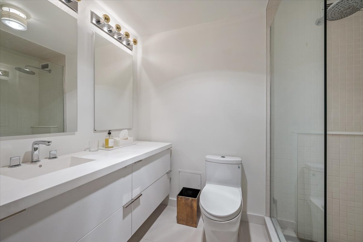 360 East Randolph Street, Unit 1002 Chicago, IL 60601 - Photo 20 of 27 a bathroom with a toilet a sink and mirror
