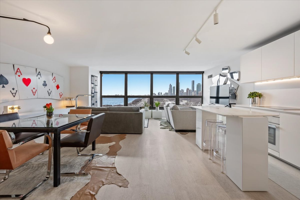 360 East Randolph Street, Unit 1002 Chicago, IL 60601 - Photo 4 of 27 a living room with furniture a rug kitchen view and a window