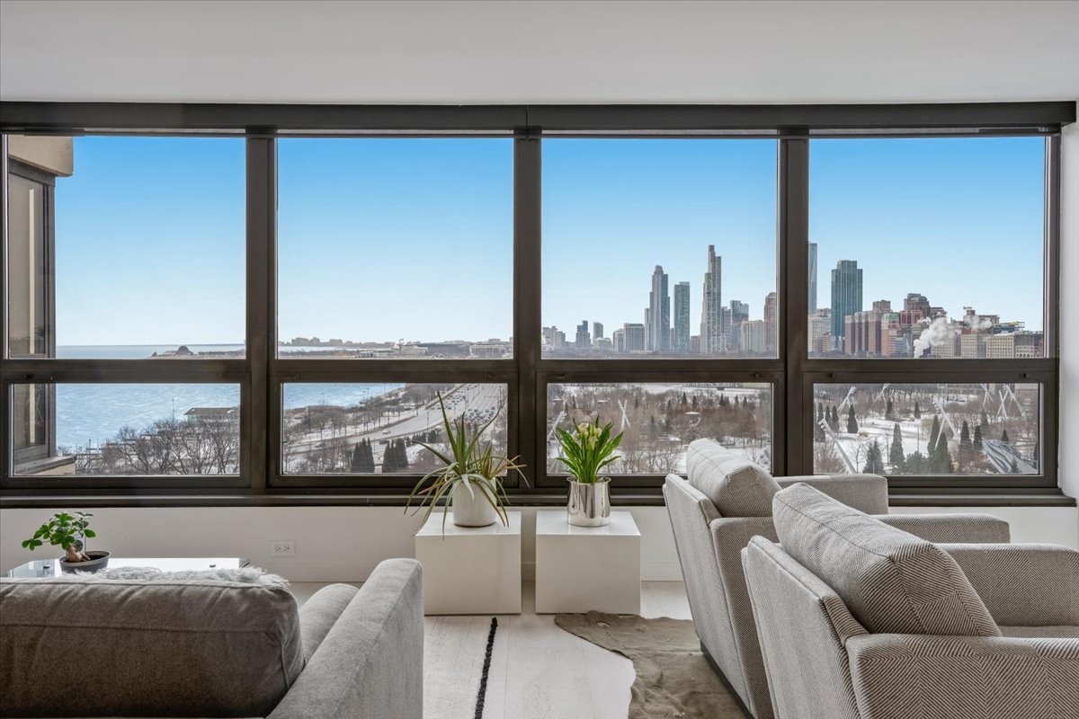 360 East Randolph Street, Unit 1002 Chicago, IL 60601 - Photo 5 of 27 a living room with furniture and a large window