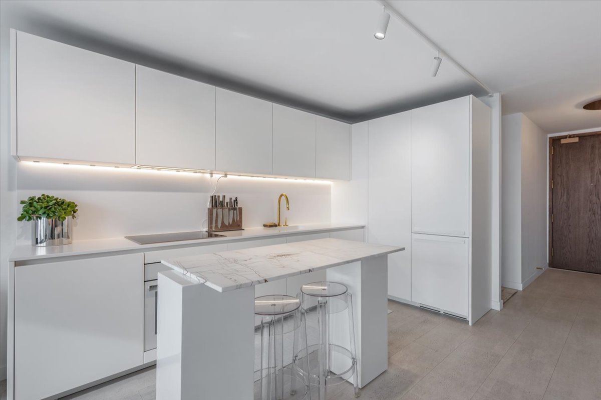 360 East Randolph Street, Unit 1002 Chicago, IL 60601 - Photo 8 of 27 a kitchen with a sink cabinets and appliances