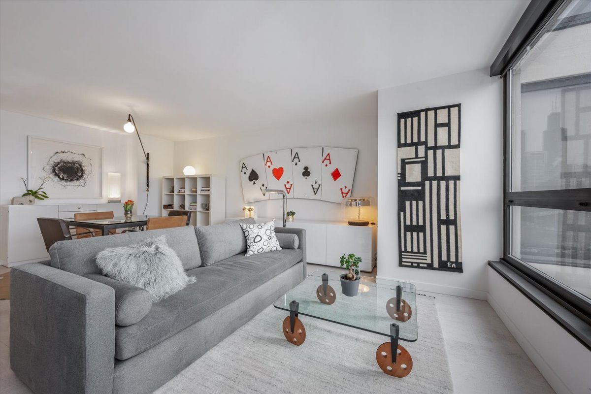 360 East Randolph Street, Unit 1002 Chicago, IL 60601 - Photo 9 of 27 a living room with furniture and a flat screen tv