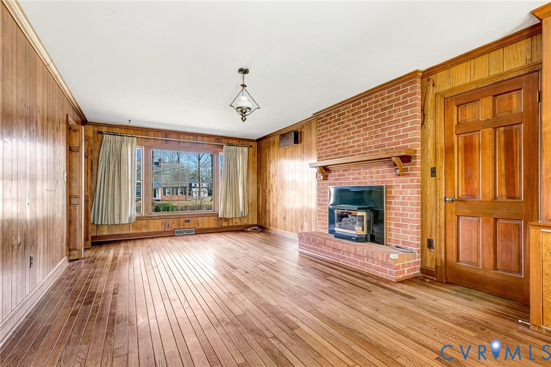 2820 Euphoria Road Chester, VA 23831 - Photo 11 of 38 Unfurnished living room with wood walls, ornamenta