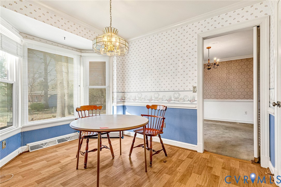 2820 Euphoria Road Chester, VA 23831 - Photo 16 of 38 Dining space with wallpapered walls, a chandelier,