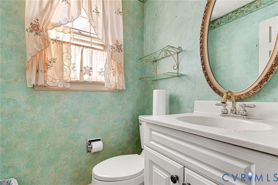 2820 Euphoria Road Chester, VA 23831 - Photo 23 of 38 Half bathroom featuring vanity and wallpapered wal
