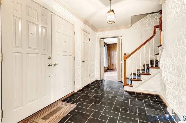 a view of a hallway with wooden floor and staircase
